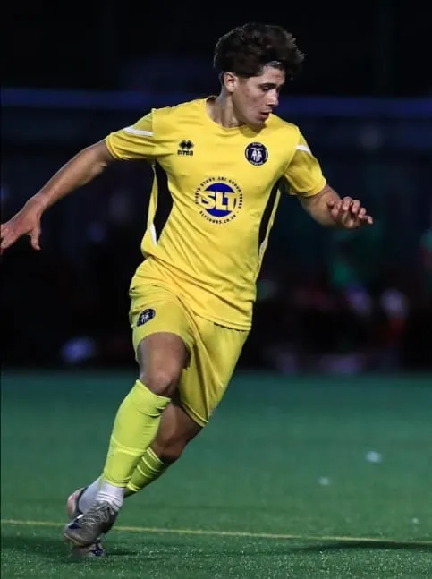 Harry Douglas in a yellow kit, moving with the ball during a match